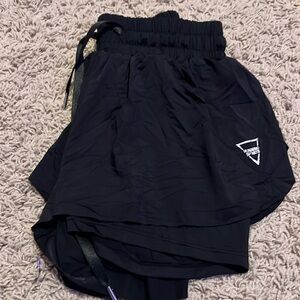 Black skort shorts with bike shorts under used for cheer. Size rubbed off